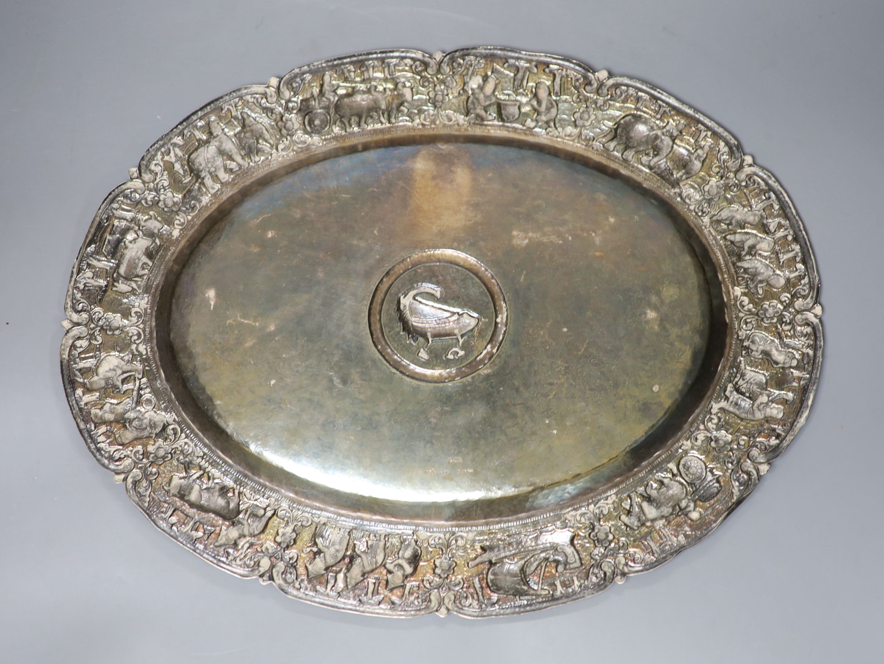 An Indian embossed white metal oval tray, with later engraved inscription and initials, 42.5cm, 27oz.